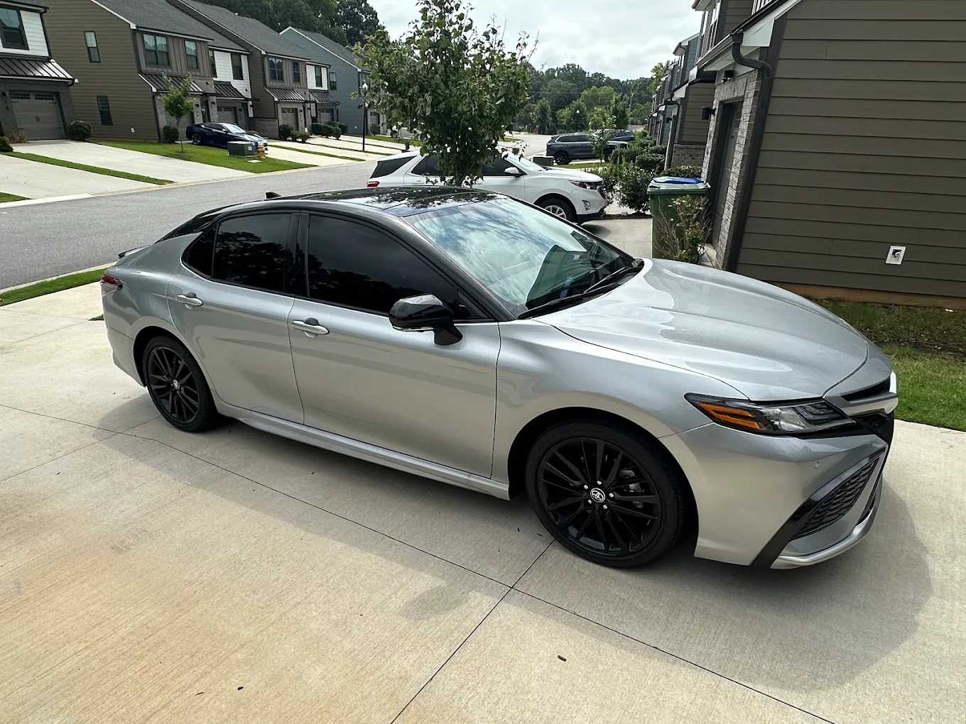 Silver Toyota Camry with completed window tint in a driveway