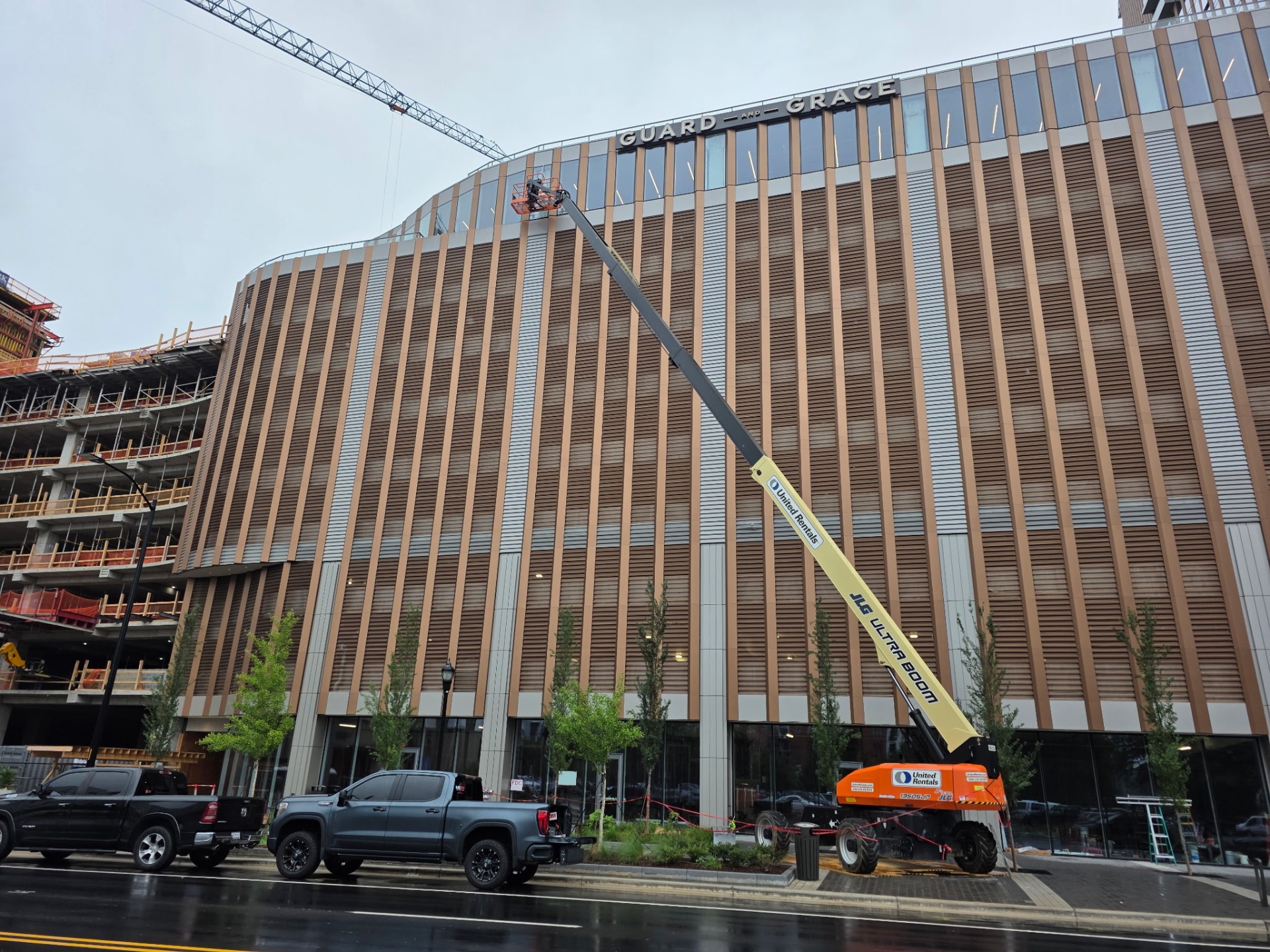 Curved multi-story commercial building with architectural window film being installed