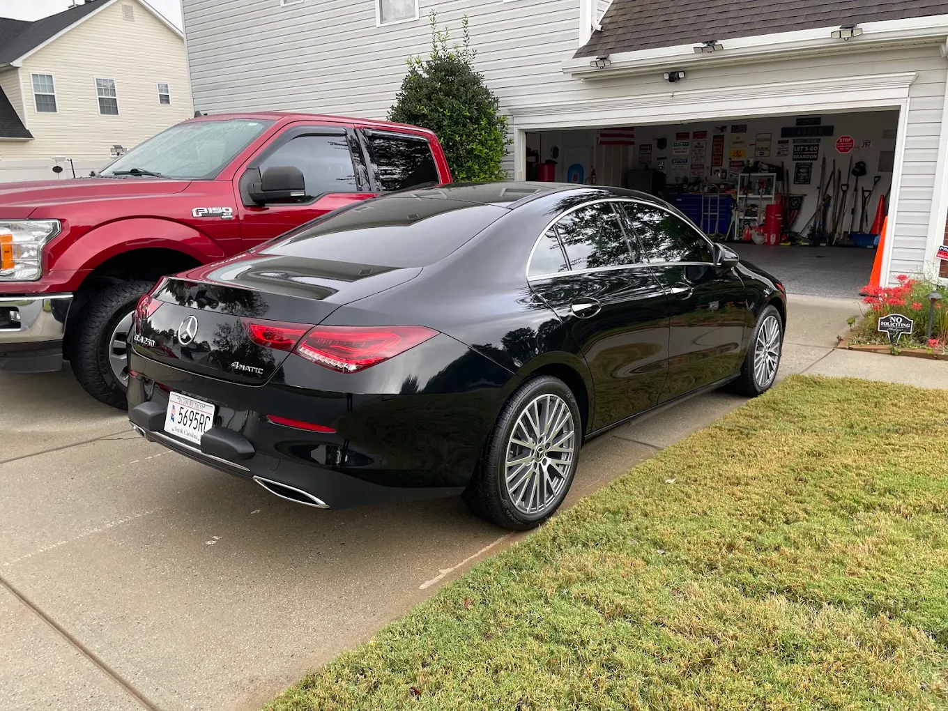 Black Mercedes-Benz CLA with completed window tint in a residential driveway