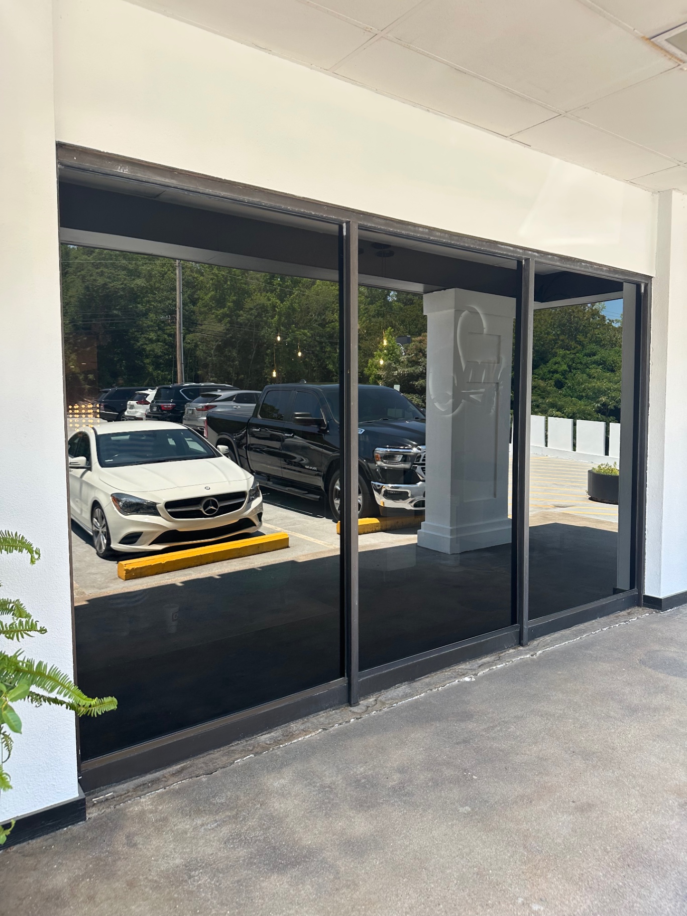 Retail storefront with full-height glass finished in dark window film